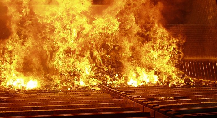 Municipal solid waste during combustion in a moving grate incinerator